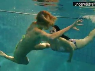 Two charming amateurs showing their bodies off under water